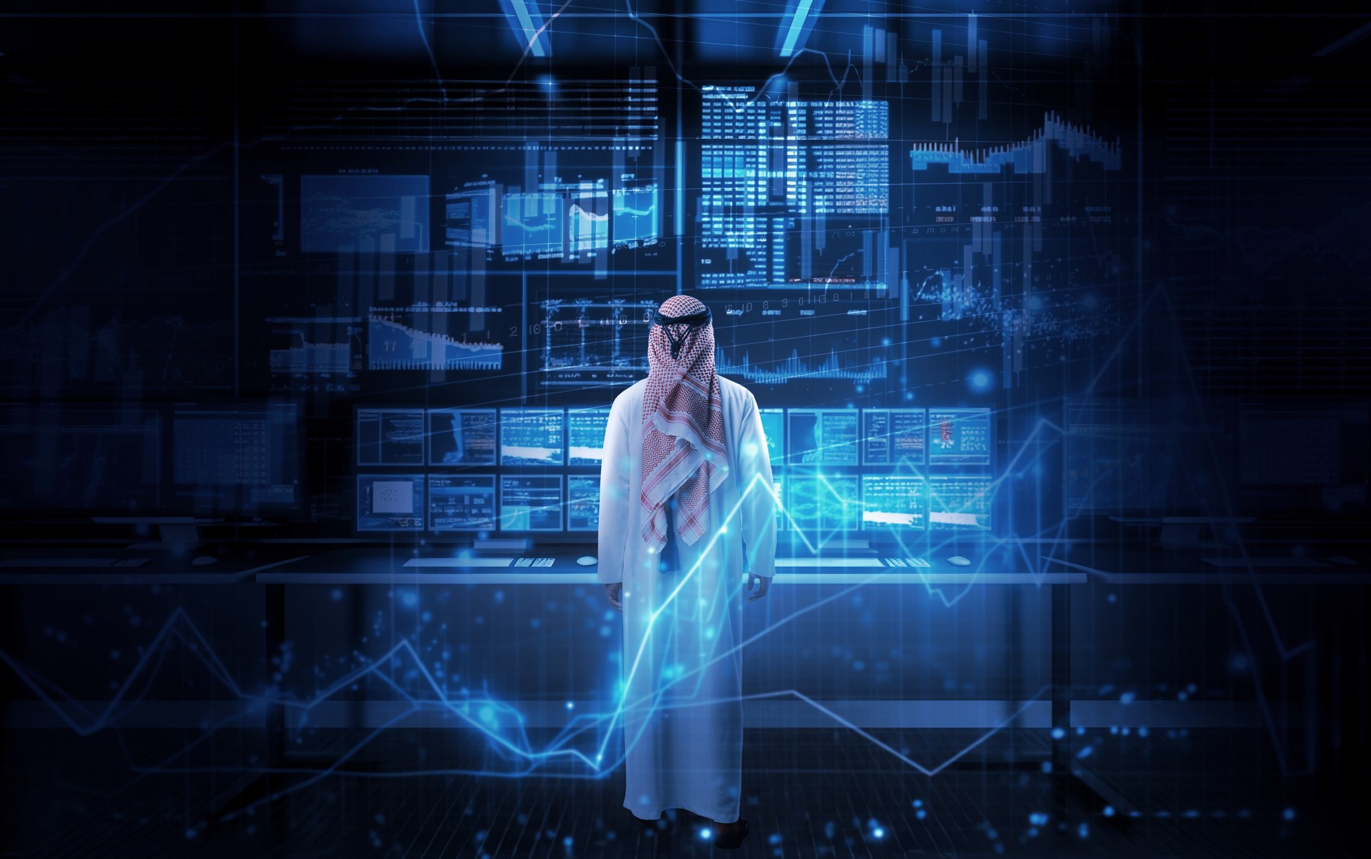 OVEEQ professional in traditional Saudi dress standing before a holographic data and analytics display, representing our Saudi-founded technology expertise